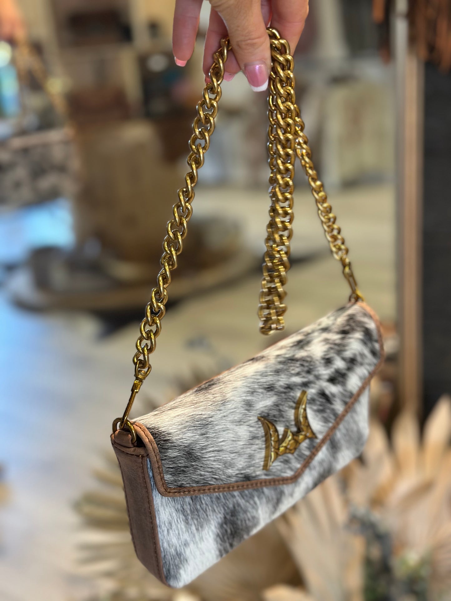 The LW speedster mini chain bag in brown and white cowhide