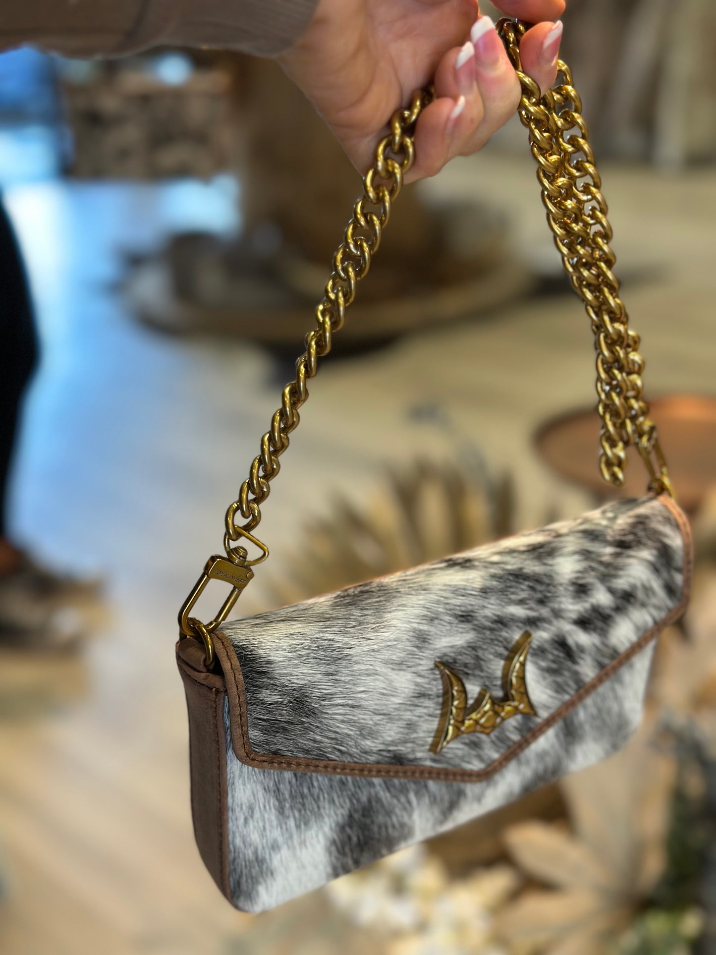 The LW speedster mini chain bag in brown and white cowhide